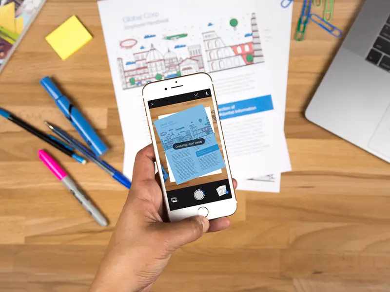 A sleek, modern mobile device in a professional, minimalist setting. In the foreground, a close-up view of the device's screen, showcasing a clean, intuitive interface for the Genius Scan PDF scanner app. The screen displays a clear, high-quality image of a document, highlighting the app's automatic edge detection capabilities. The device is positioned on a smooth, light-colored surface, casting soft, natural shadows. The background is slightly blurred, conveying a sense of focus and emphasizing the app's simplicity and efficiency. The overall scene radiates a sense of productivity, efficiency, and technological sophistication.
