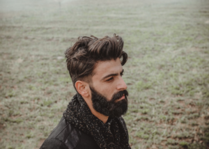 man in black leather jacket standing near body of water during daytime — Foto por SAJAD FI na Unsplash